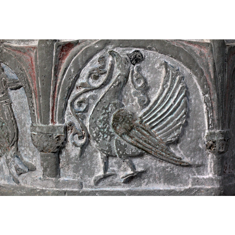 on the east side of the basin [orientation is approximate] -- A peacock passant, facing left; an acanthus branch hangs from its beak; anther, smaller, branch behind its head, though it may be part of its crest