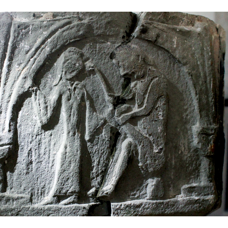 on the northwest side of the basin [orientation is approximate] -- the Thorn Extractor [aka Thorn-puller / Spinario], sits on a rock on the right of the scene, facing left. A woman stands to the left, dressed in long gown, tight waist, long sleeves at the cuff; she wears a head piece of some sort. It is difficult to ascertain which way her face is turned, but her feet point left, away from Spinario. Unfortunately this is a most damaged side and is therefore not possible to discern all the details of the scene.