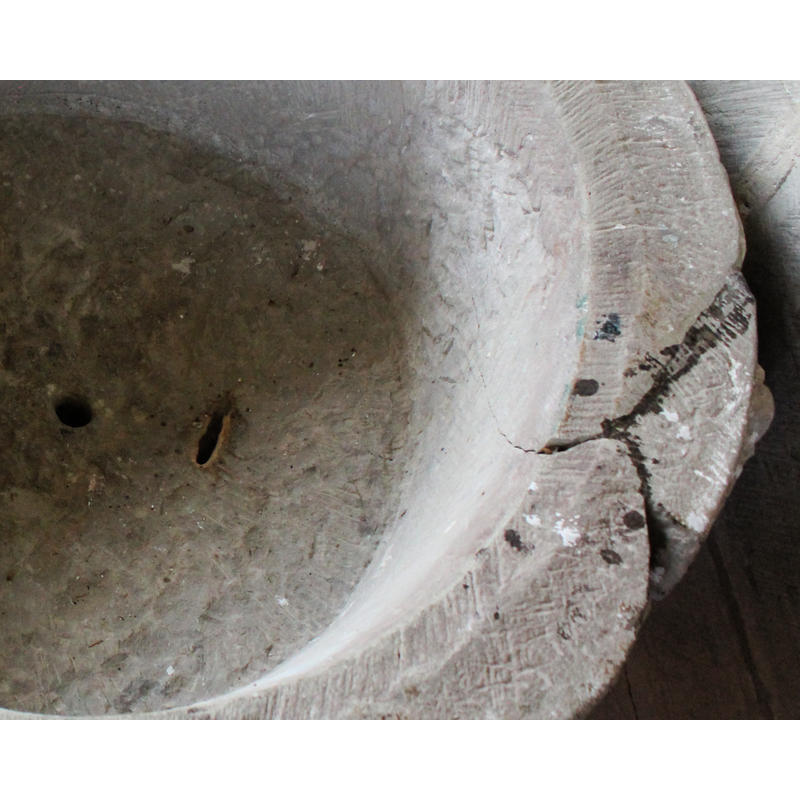 the central round hole is the drain; the elongated hole next to it, to the right, appears to be a flaw of the stone