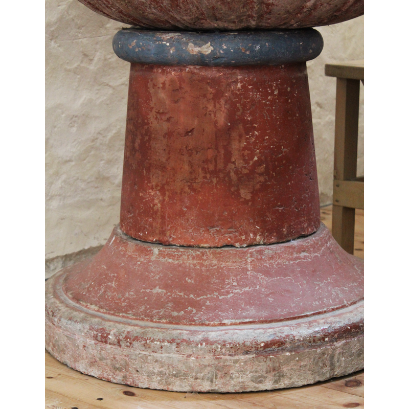 atop the pedestal stem of the base; painted blue