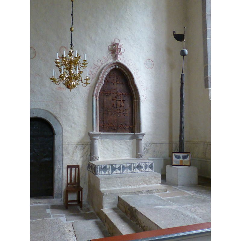 the sacristy door, the tabernacle and an old weather-vane