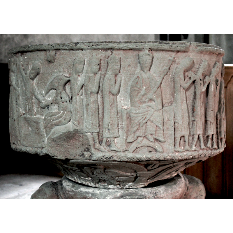 on the northeast side of the basin [orientation is approximate] -- This scene is either Herod giving orders or Christ enthroned, either way, a very odd depiction of an enthroned figure; to the left stand three figures, in profile, facing right; all three are crowned, and have hands raised in a prayer pose; their gowns reach to half their calfs, and all wear capes; to the right of them is a seated figure, enthroned and crowned, not haloed; he sits in a full frontal pose, the right arm diagonally pointing towards the right; the left arm holds a staff which might be a double-cross or fleur de lis with two leaves (?) [recheck the iconography for this type of staff]