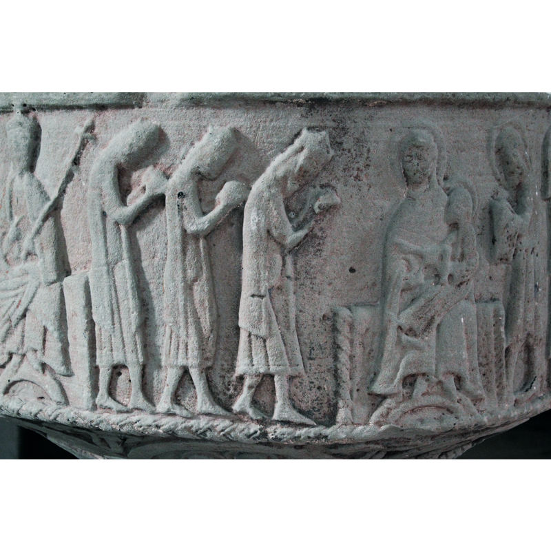 on the north side of the basin [orientation is approximate] -- This scene involves six figures: to the left are the three crowned Magi in profile, wearing half-calf tunics and mantles; they carry gifts without cloths under the gifts; their heads are bent in adoration. To the right of them Mary and Child are enthroned; she sits full frontal, her haloed head turned slightly towards the Magi, her feet resting on a rainbow-stool; Mary holds Christ, who sits in profile, haloed, his right hand pointing to the Magi, his left hand holding a scroll. To the right of Moadonna and Child stands a haloed figure in profile, facing left, Joseph; his hands are covered and hold something, probably a dove.