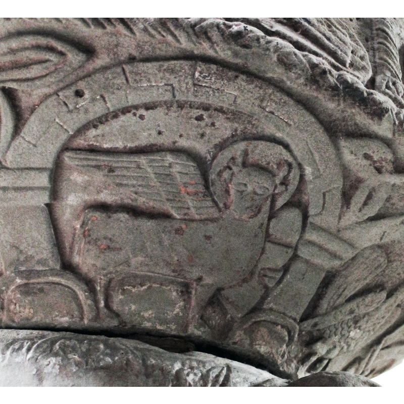 on the south side of the underbowl [orientation is approximate] -- a winged ox passant-gardant holding a book