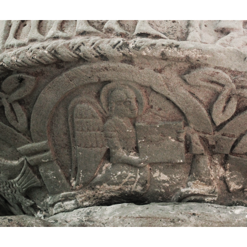 on the northeast side of the underbowl [orientation is approximate] -- A haloed angel demi-figure facing right and holding an ope book with both hands.