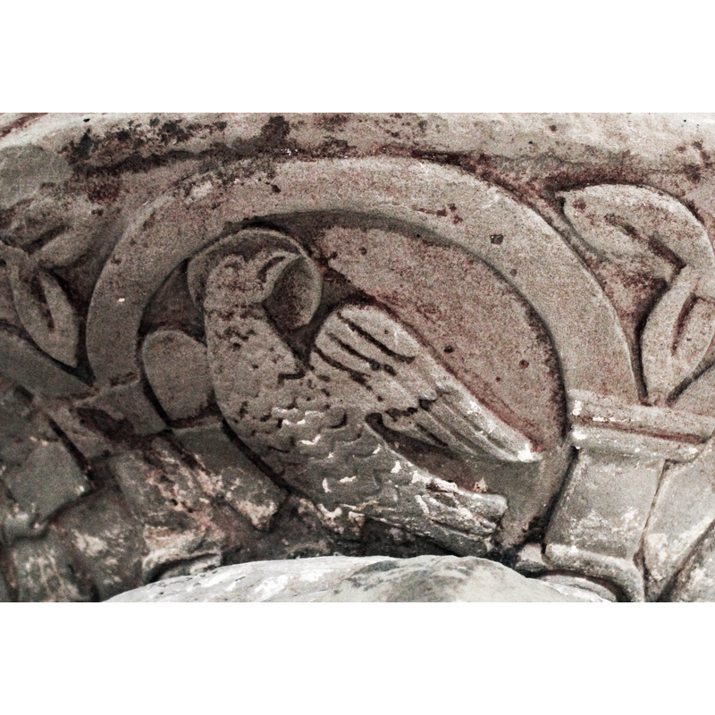 on the north side of the underbowl [orientation is approximate] -- a winged eagle, haled. Body faces left - head turned to the right. Holds a book.