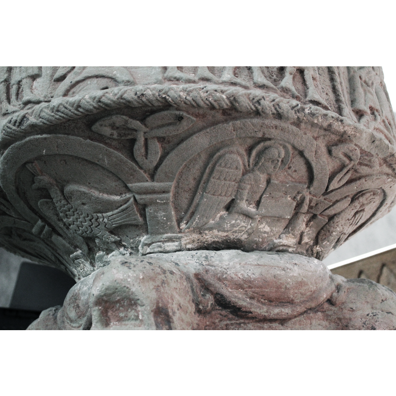 six of the arch-heads appear plain but the one in which Luke symbol stands is patterned showing the construction blocks; some of the bases have floral or plant motifs on them; the capitals are not identical either