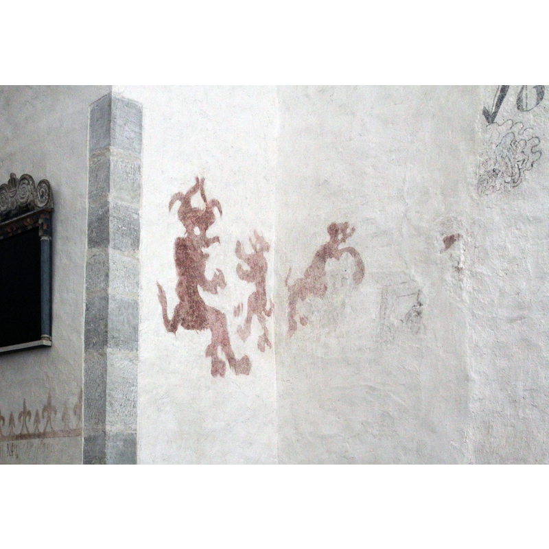 these partial remains are located on the corner of the north wall of the nave (right) with the north wall of the tower arch (left)