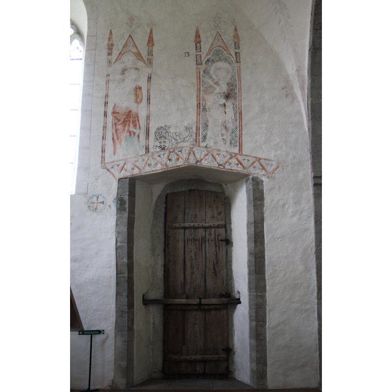 the doorway just east of the chancel arch