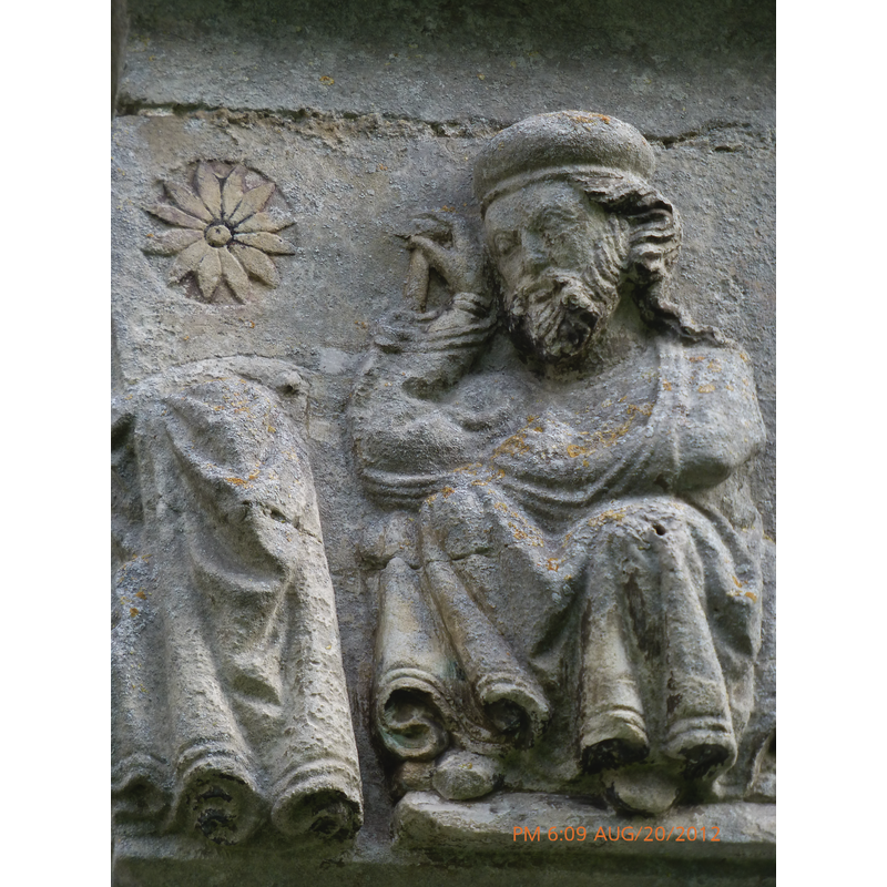 Nativity with Dream of Joseph scene; detail: seated Joseph dreams away with his eyes closed; his right hand rests on a T handle staff, left handle inside the mantle and across his middle