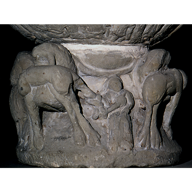 visible only betwen the beast's heads; the thinner curved moulding on it is probably the body of a snake