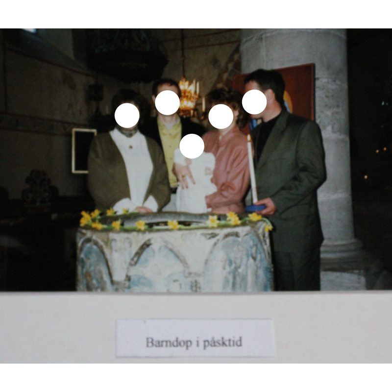 modern baptism scene at the Stenkyrka font [date unknown; photograph posted inside the church; faces erased to protect privacy]