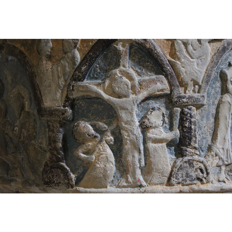 The Crucifixion of Christ. Christ appears nailed to the cross, his head framed in a crossed halo, bent slightly to the left; his feet are not crossed; to the left, a figure of soldier holding lance, piercing the side of Christ - to the right, stands a figure holding a club in the action of beating Christ. In the spandrel a figure with long flowing hair appears to be holding or fighting a person? a beast?