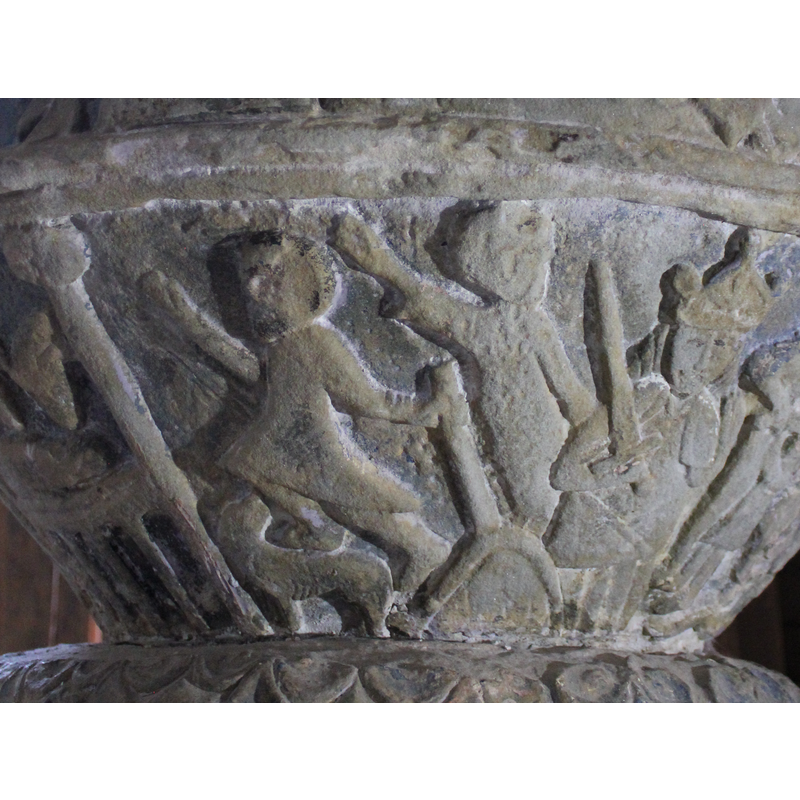 The next scene to the right, two figures, appear to run to the left. Their right hands are raised and pointed diagonally upward - the scenes of the last supper and Christ's temptation are directly above this scene - under the first figure there is an animal, a dog, facing left, head turned back and looking at shepherd. The first shepherd holds either a spade or hoe (a farmer?). The figure to the right, just left of Herod, could be the announcing angel, although there are no wings present.