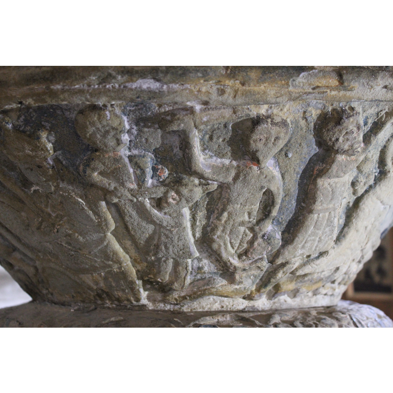 The figure to the left is seated, crowned, full frontal, right hand holds the sword to the chest pointing upward, the left hand bends up with palm showing. To the right of Herod, are two soldiers, holding children with their left hand and swords on the right in the action of slaughtering them
