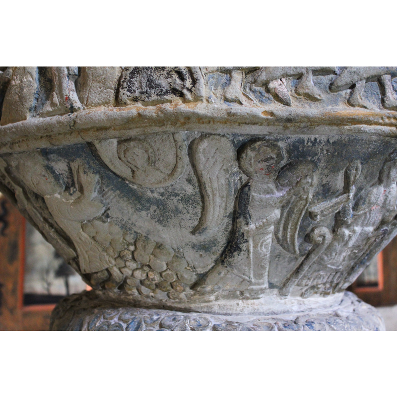 Stephen stands by a pile of stones raises his arms towards an encircled bust -- to the righ stands an angel in profile holding a scroll and facing the enthroned figure at the extreme right