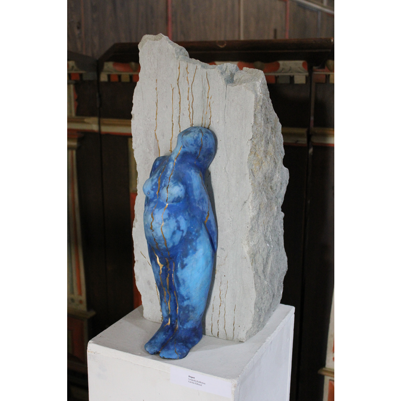 one of three modern sculptures by the same artist on the wall of the chancel