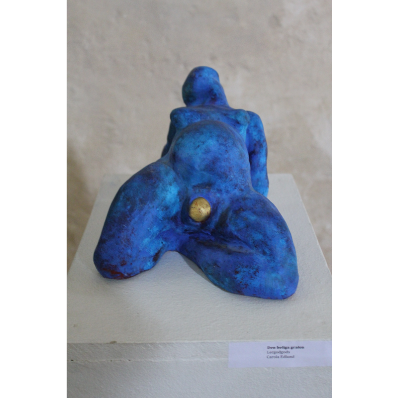 one of three modern sculptures by the same artist on the wall of the chancel
