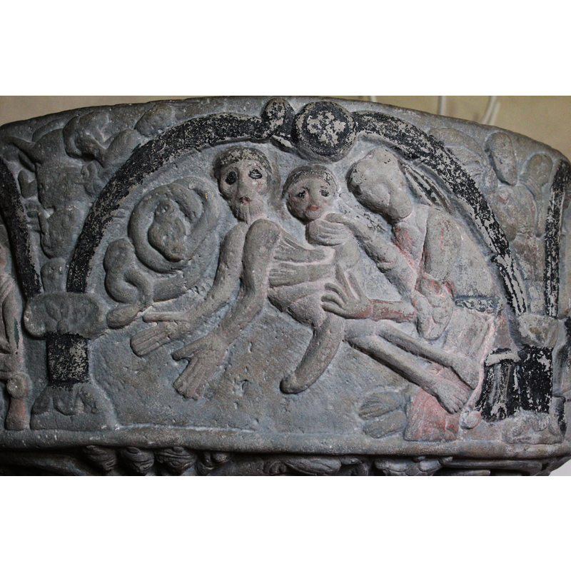 This program moves from the right to the left. In one arch the scene of God creating Eve is shown. God is on the right sitting on a throne (stool) and pulls Eve from Adam's ribs. God's face is turned to the viewer. Body in profile. Right hand holds Eve by the neck and left hand around the thigh. Eve's body is in profile.  Her leg goes down. Adam's body is stretched horizonally across/ diagonally across the scene - head turned to viewer (as was Eve's head) and arms extended with palms open. To the left is the coiled snake.  IN THE SPANDREL FOLLOWING THE SCENE (TO THE LEFT) Samson fights the lion