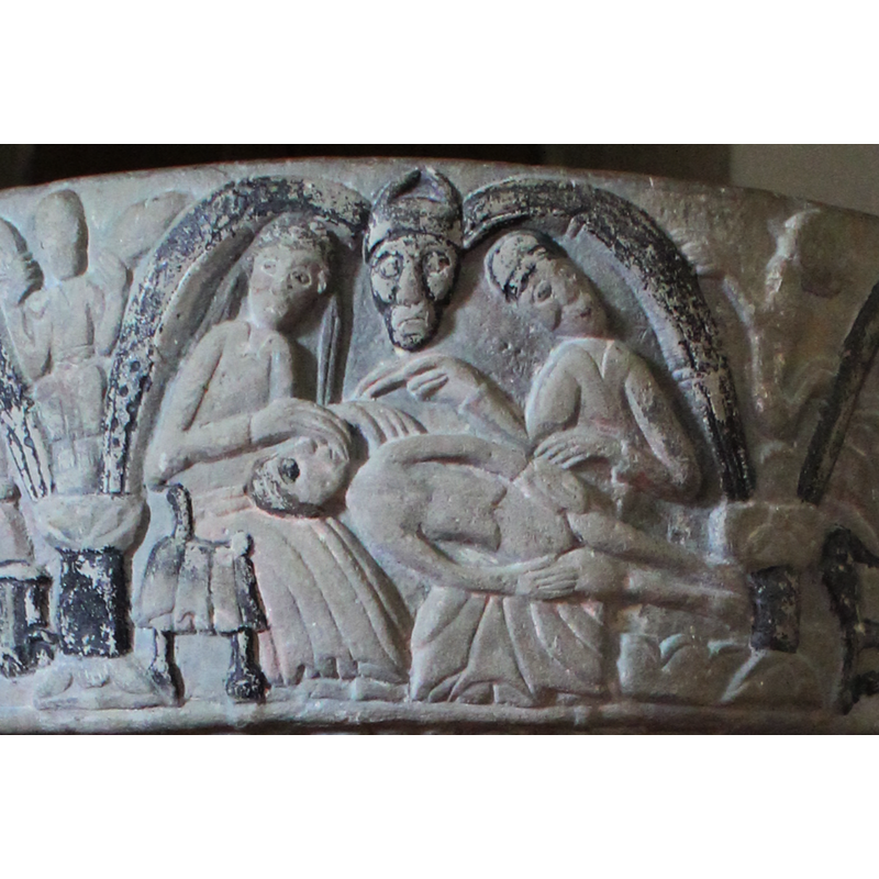 On the left sits an angel with the head of reclining figure on its lap. Adam lies horizontal; angel's right hand over the face of Adam; angel looks at viewer. To the right the figure of God, (full frontal) wears a hat, head inclined over right shoulder; right arm bent at elbow and raised, right hand has two-finger sign of benediction over the head of Adam; the left arm rests above Adam's left hand. Across the middle is the naked body of Adam, head facing upward. IN THE SPANDREL a seated angel, hands holding its wings
