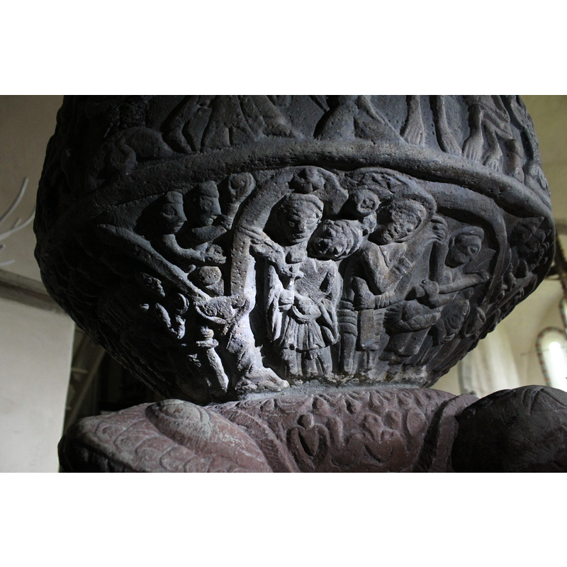 In this arch there are four figures (UNDERSIDE OF BOWL) ARCH NO.3  To the right stand a figure without the head. Next to it stands a figure holds an axe in left hand across its chest. Its right hand point to the left. The next figure stands full front, left arm close to body and holding a long object (sword or club) Right hand points (two fingers in benediction across chest. The Figure to the left (Madonna and Child?) is woman holding a child in left arm - she holds the cross to her breast and the child right arm, diagonally across mother's chest is extended and is in benediction. Left arm holds her mother's left thumb. In SPANDREL two fgiures holding round objects in their right hands.