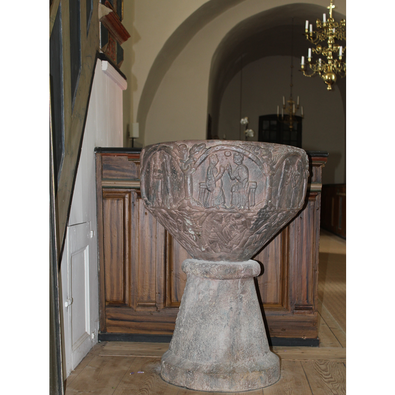 an unfortunate location of the font inside the church, both liturgically and from the point of view of access to the iconographic programme in the basin, as the view of the south and west sides is greatly impeded by the proximity to the stairs to the pulpit and the pews behind the font