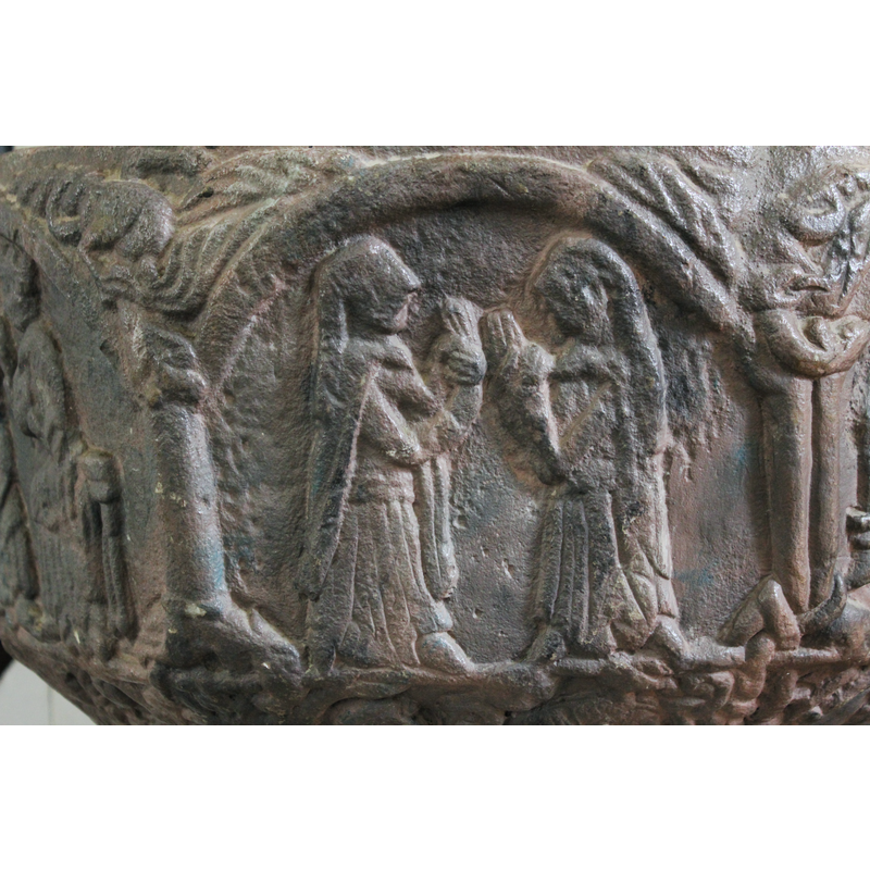 on the northeast side of the font [orientation is approximate] -- [cf. John 11:5] Two female figures in profile, robed and wearing matles; they both have long braids; their right hand, thumbs upwards, and their left hand is around the wrist of the right hand in a griving gesture