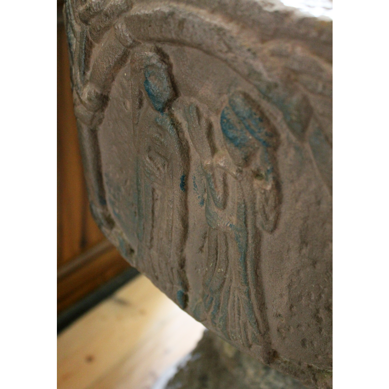 on the south side of the basin [orientation is approximate] -- Two female figures, both wearing braids. The figure on the left stands full frontal and faces the right. She wears a robe and a mantel. Both hands hold the mantel tightly. The figure on the right stands in profile, dressed like the other, the left hand holds the mantel at the waist, the right hand is extended and palm open toward the face on the left.