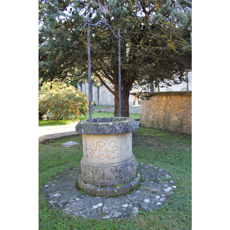monastery extramural gardens: well-head with replica sculptures (Labours of the Month?); detail