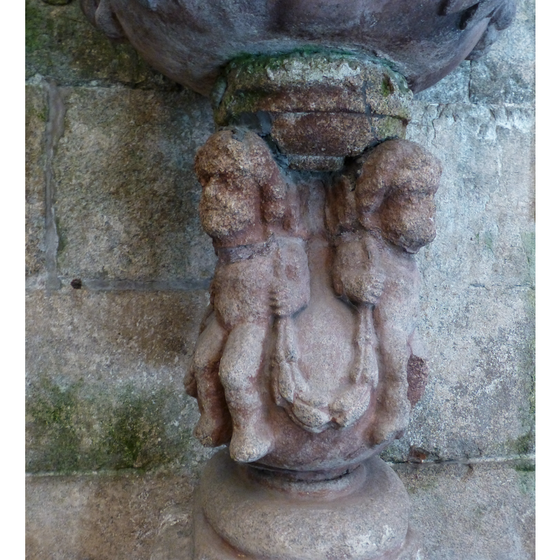 below the putti (?)