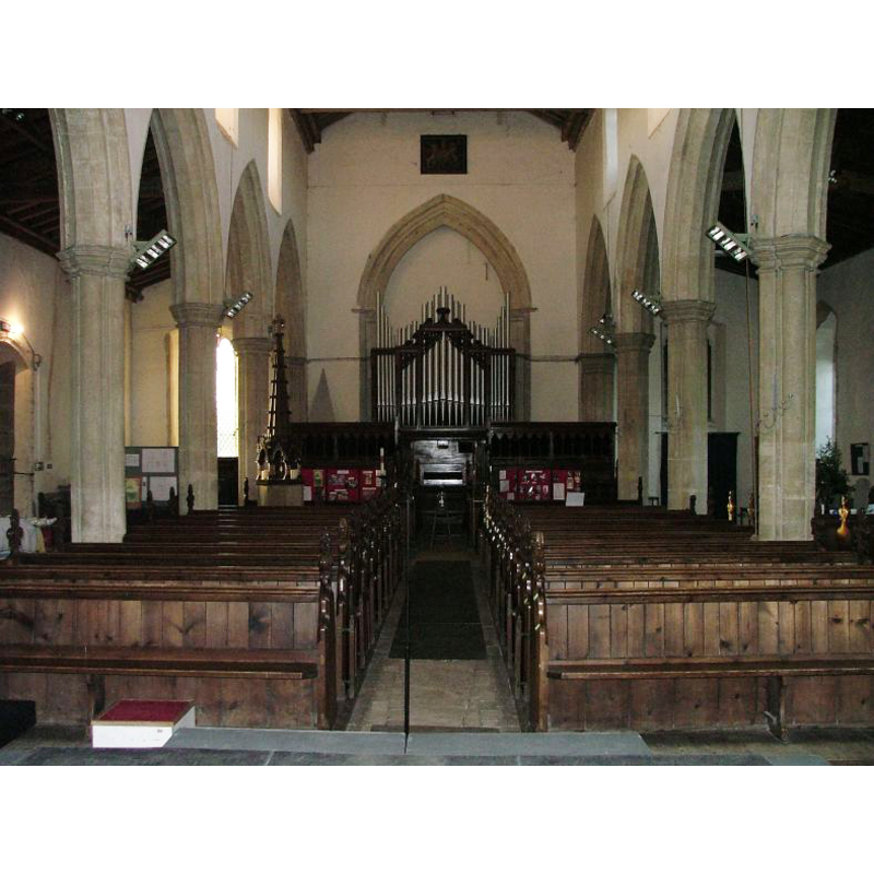 the font and its tall cover are visible towards the left (south) bank of pews