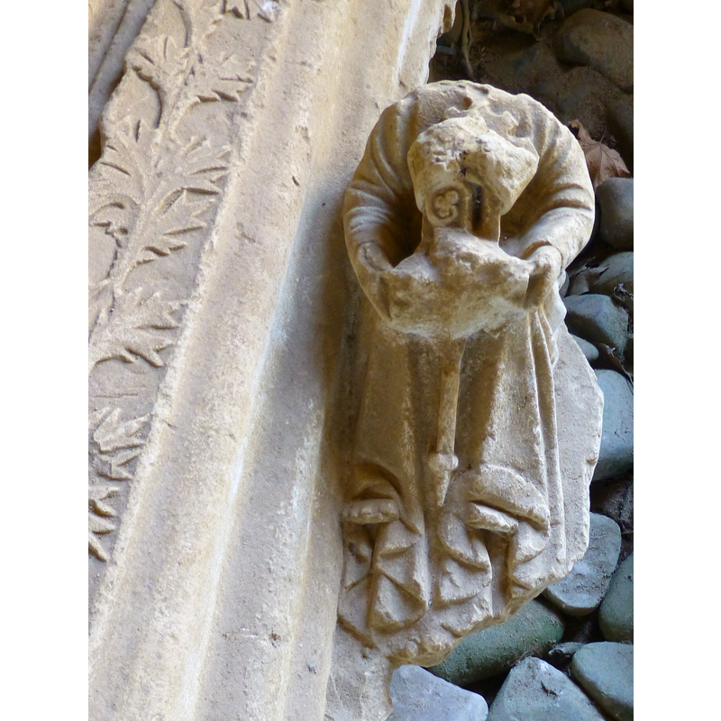 one of the two seated figures; note the abbatial baculum