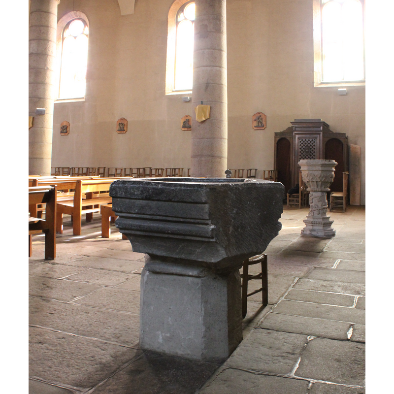 seen here with the baptismal font (?) at the back