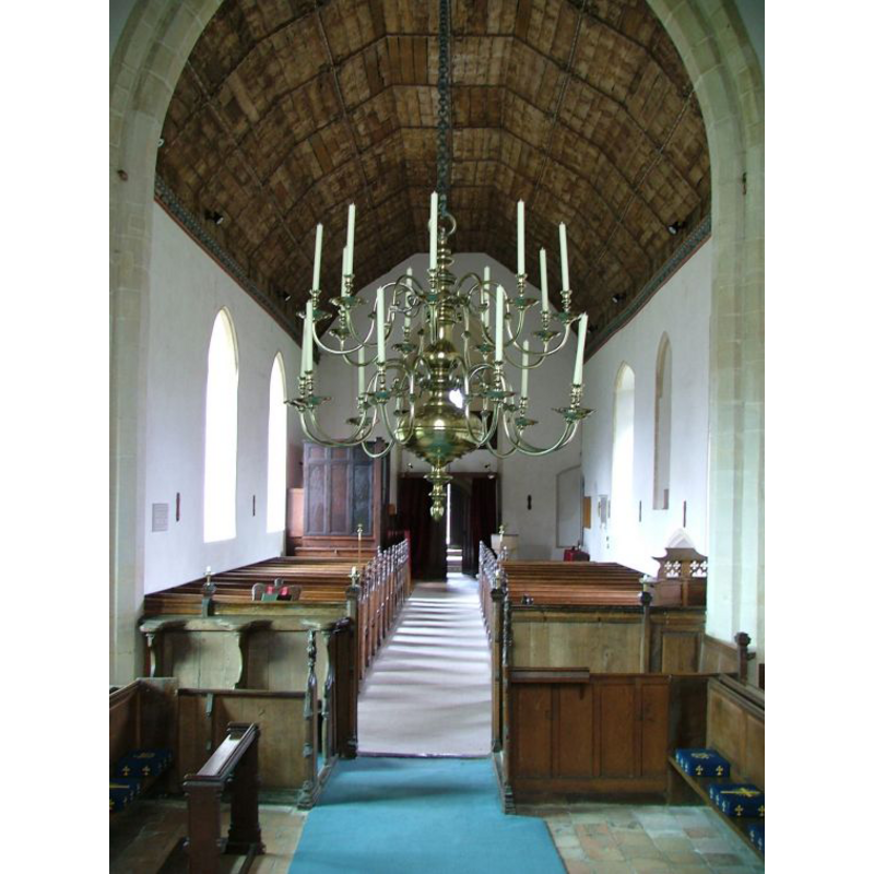 the top of the font is visible at the back (west), right side (north) side, just east of the tower arch