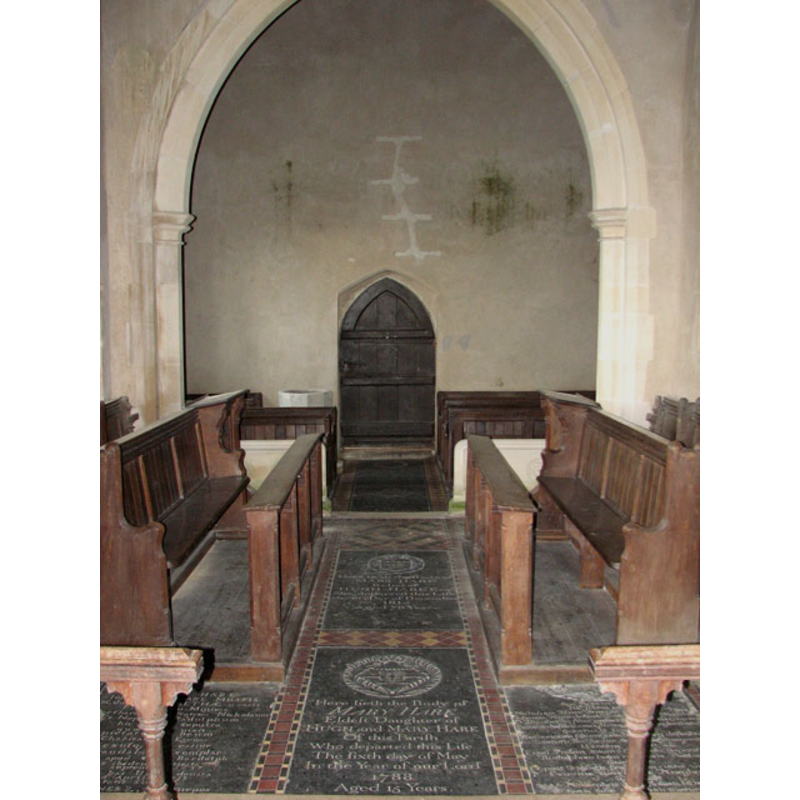the top of the font is visible to the left (south) of the doorway