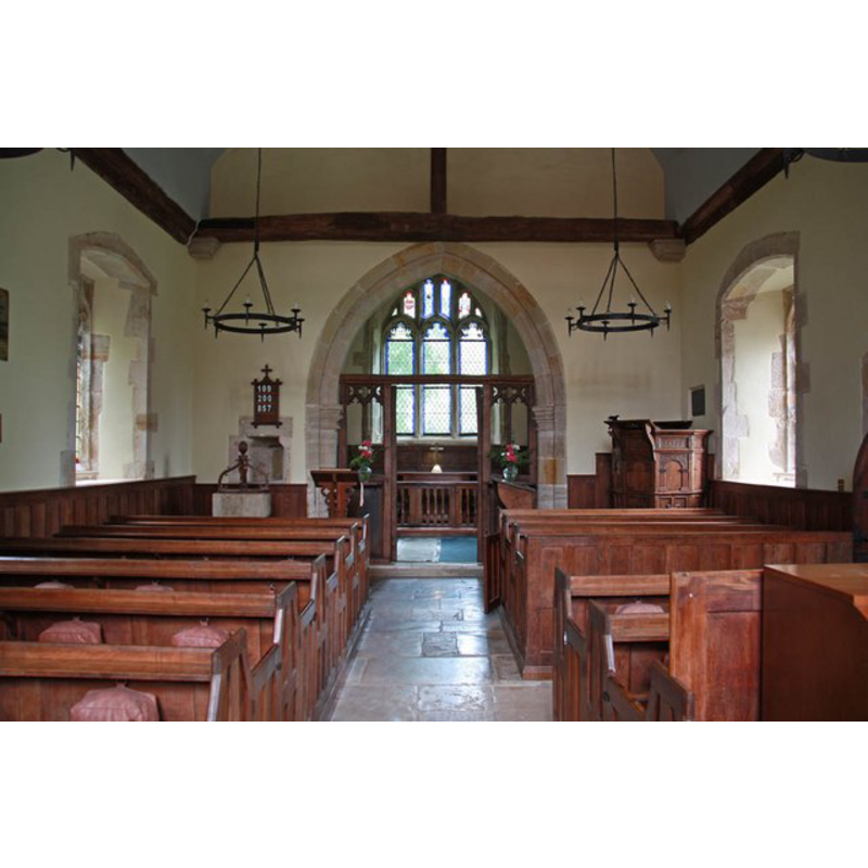 the top of the font and cover are visible at the east end, north (left) side, just west of the chancel arch