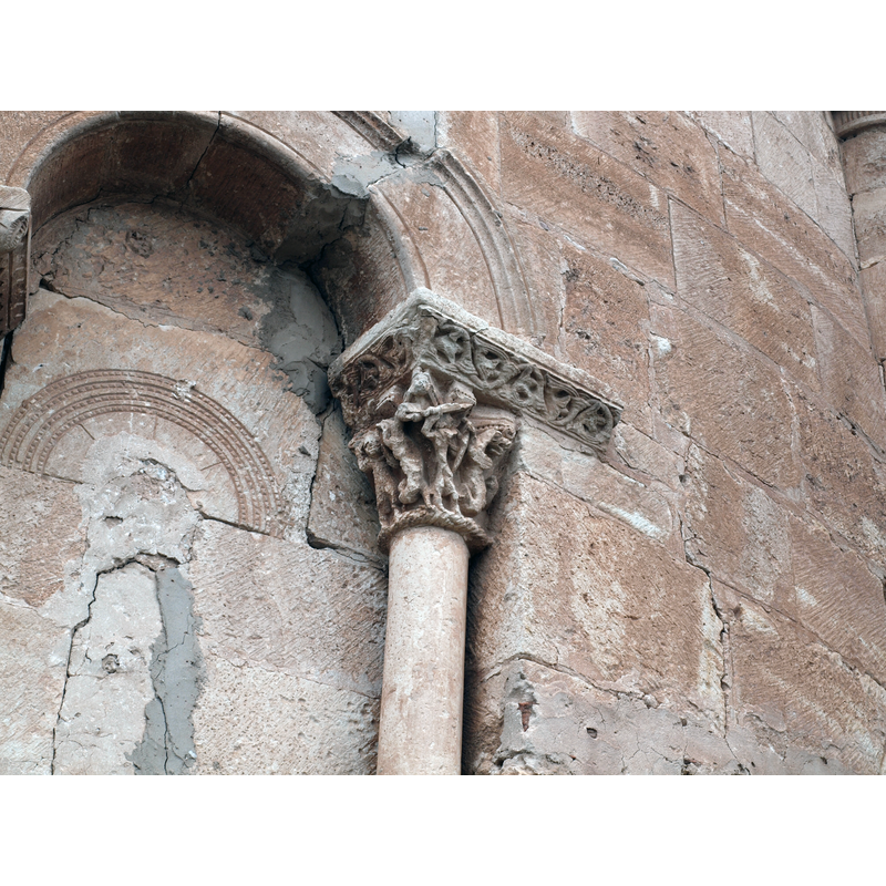 capital on the north side of the apse window; two knights/warriors armed with sword and shield fight unidentified beasts