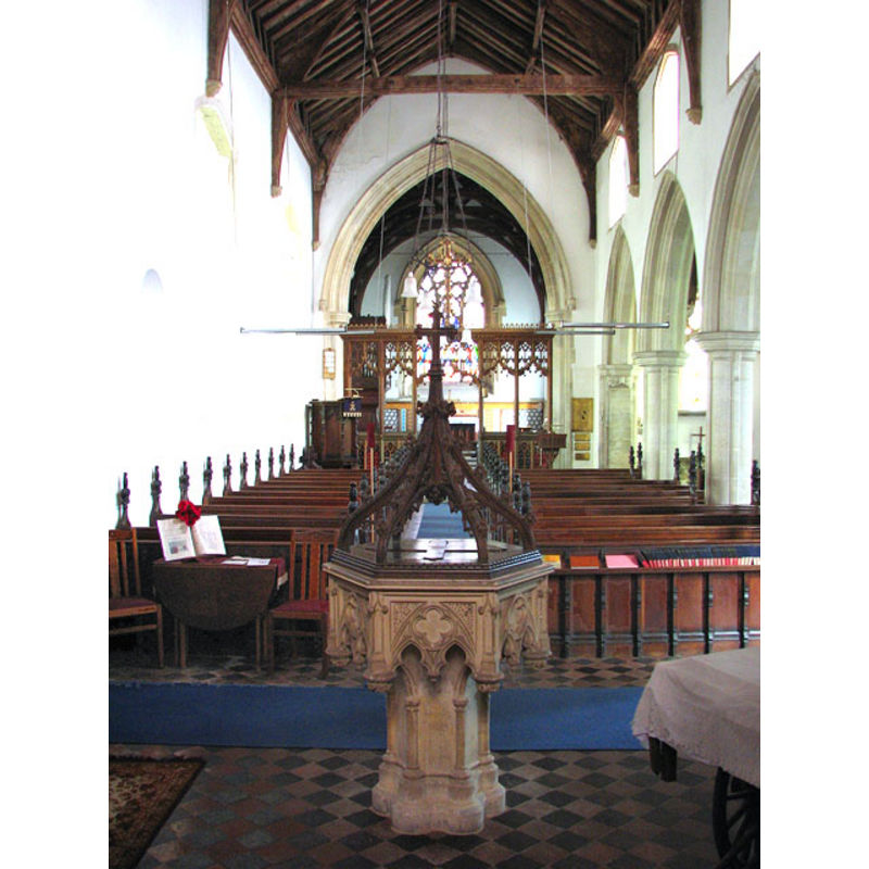 the modern font at the west end of the nave, looking east
