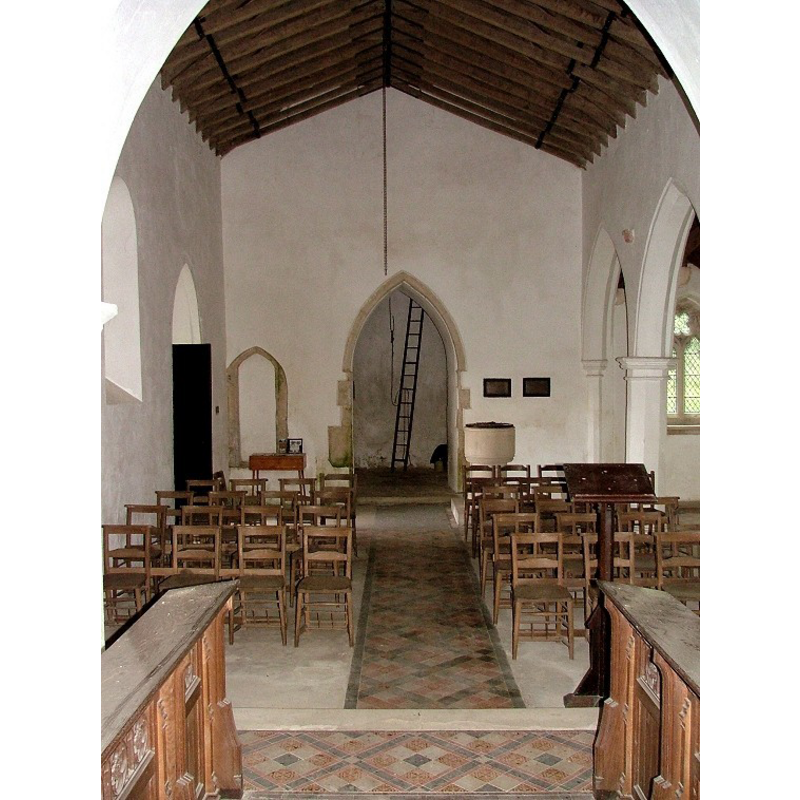 the modern font and cover at the west end, right side (north) of the tower arch