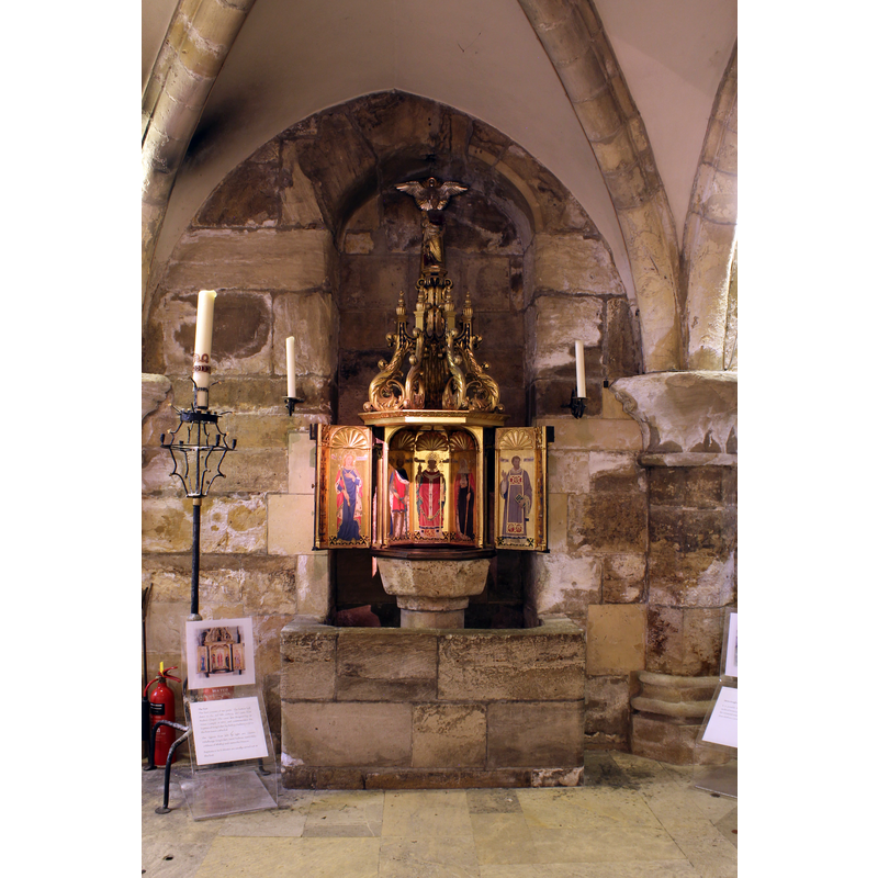 the mid-15th century font and mid-20th century cover inside the crypt
