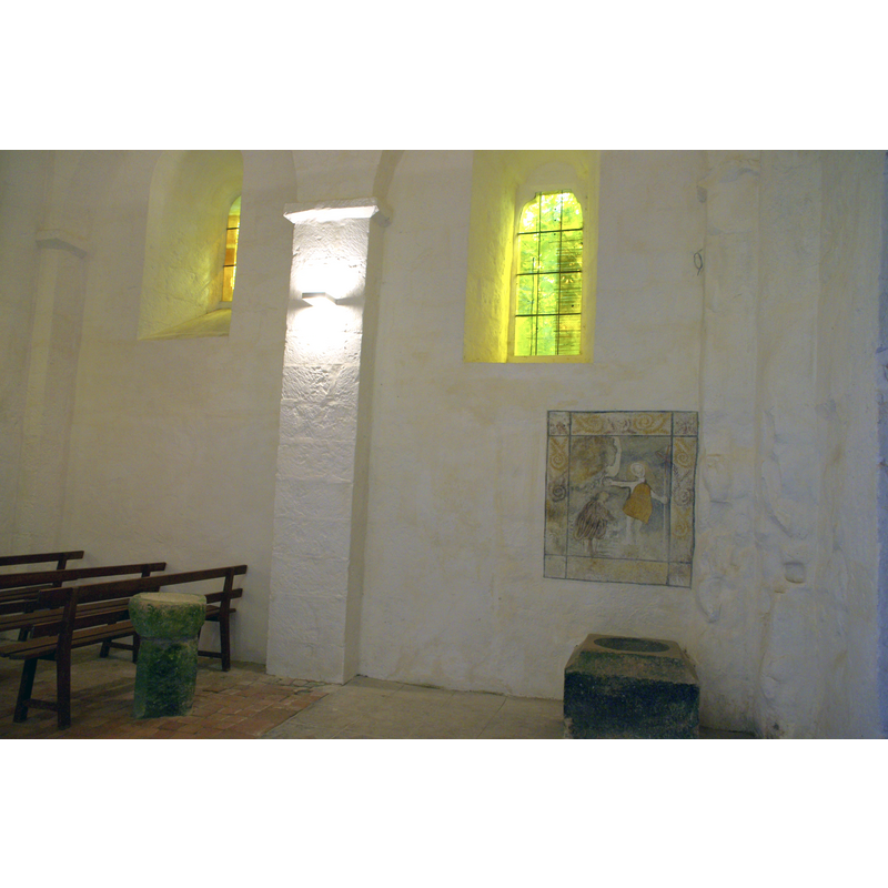 the baptistery area, showing a font, a stoup and a mural painting of the Baptism of Christ