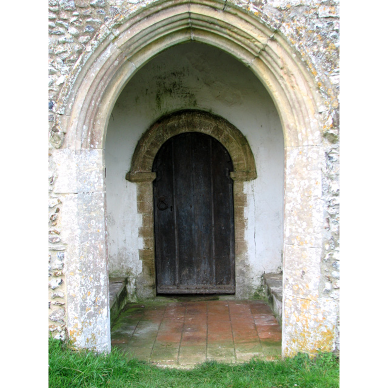 the arch of this north porch is Early English, but the doorway inside is Norman