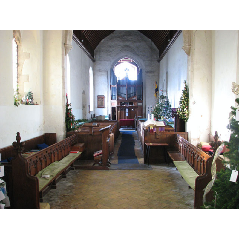 the font partially visible at the back (west), behind the left (south) bank of pews