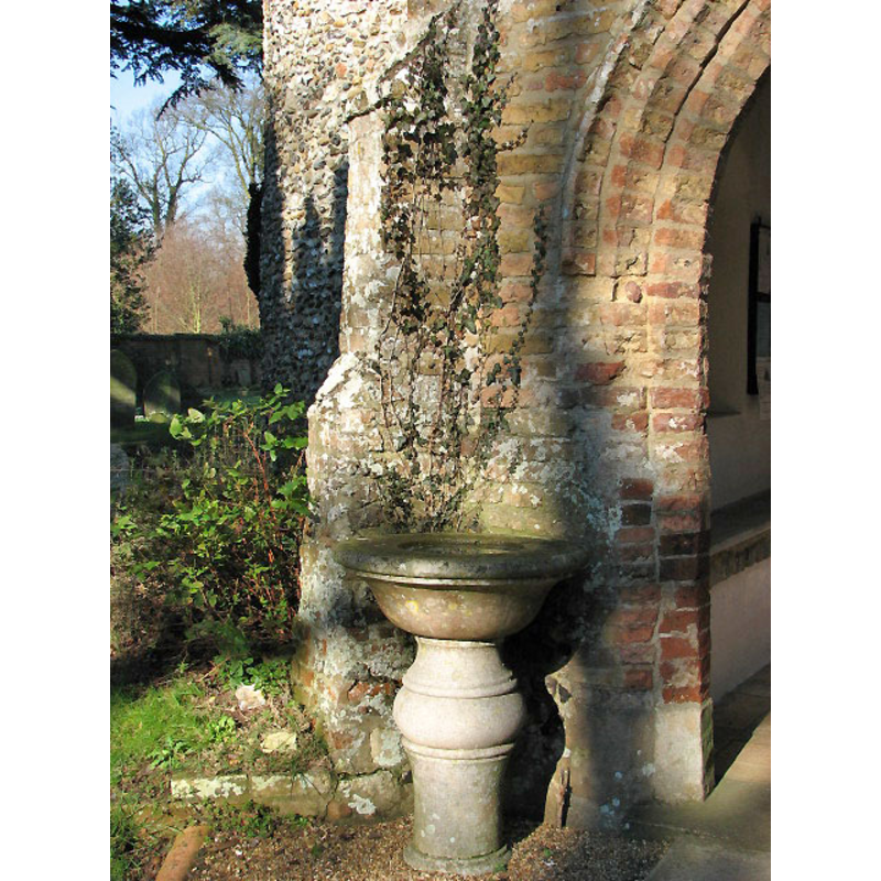 the former font now serving asholy-water stoup outside the south porch