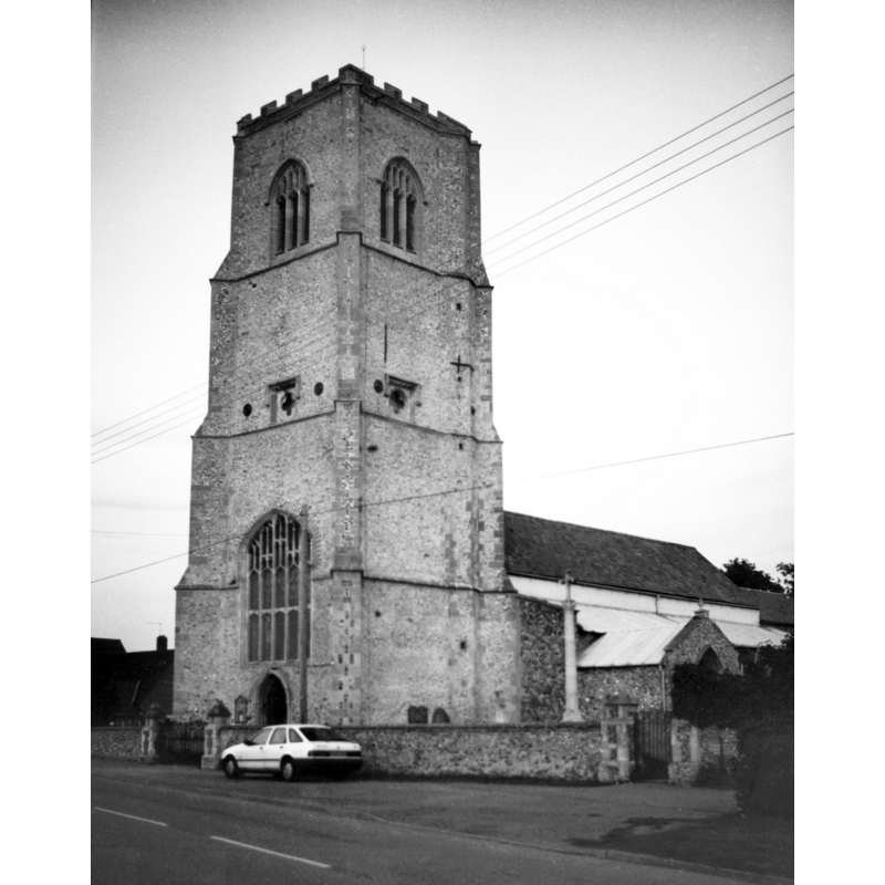photograph caption: "A fine 15c west tower with quatrefoil sound-holes."