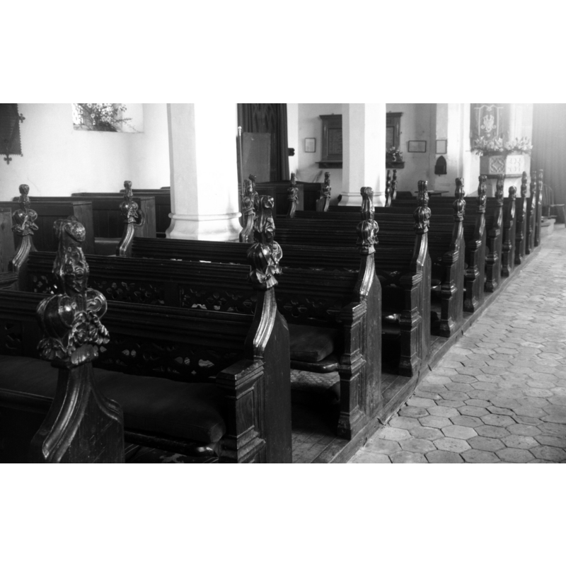 the font is visible at the far back (west end) -- photograph caption: "15c benches"
