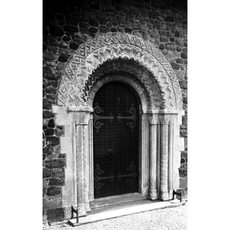 photo caption: "Almost rebuilt in 1852, but the Norman doorway, formerly in the north porch, was rebuilt at the west end"
