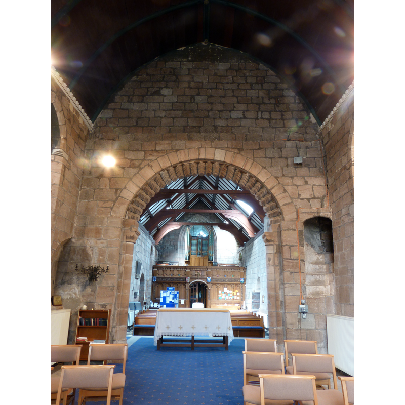 photograph taken from the east end -- the top of the font is visible at the far back, partly covered by the additional altar