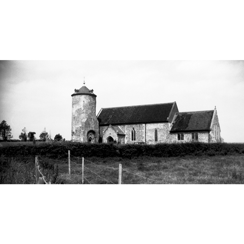 Photo caption: "The detached tower is pre-conquest. The walls of the church are mainly Early English"
