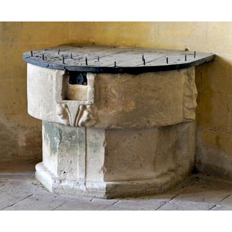 on the right side of the basin, next to the wall; appears frilly or leafy